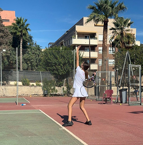 jugadora de tenis sacando